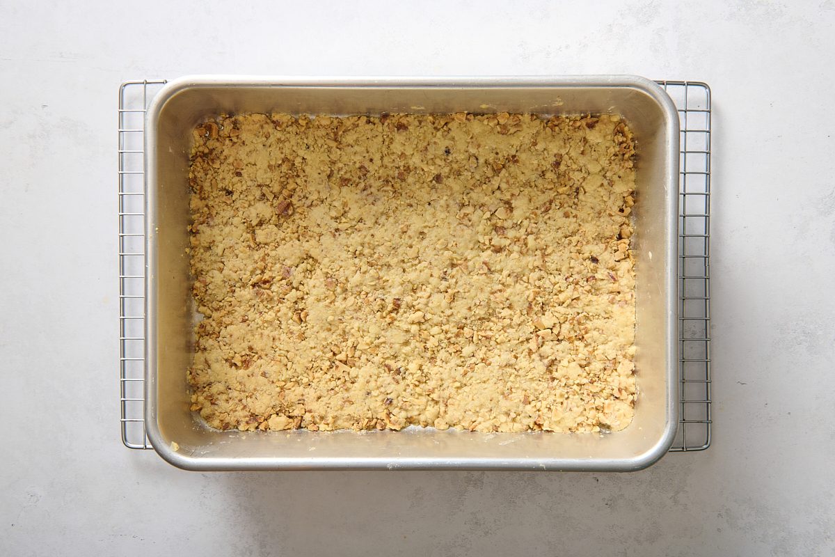 Baked crust in a pan cooling on a rack