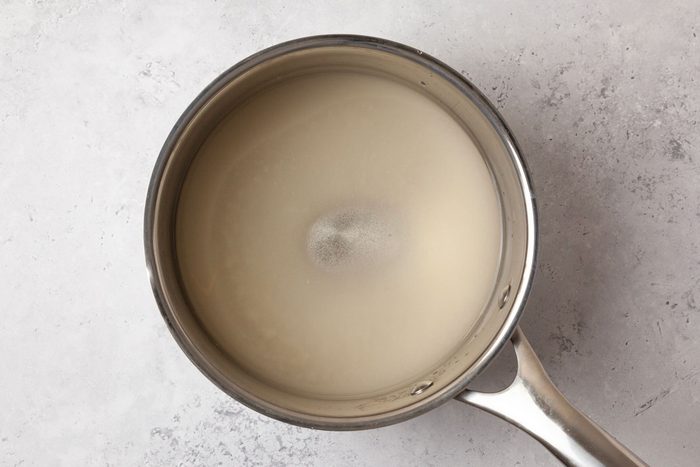 Step 2 of Butterscotch Hard Candy is to boil the sugar and corn syrup and water