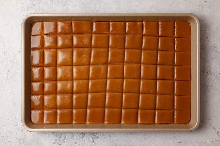 Step 5 of Butterscotch Hard Candy is to pour into pan and cut into squares when almost cooled