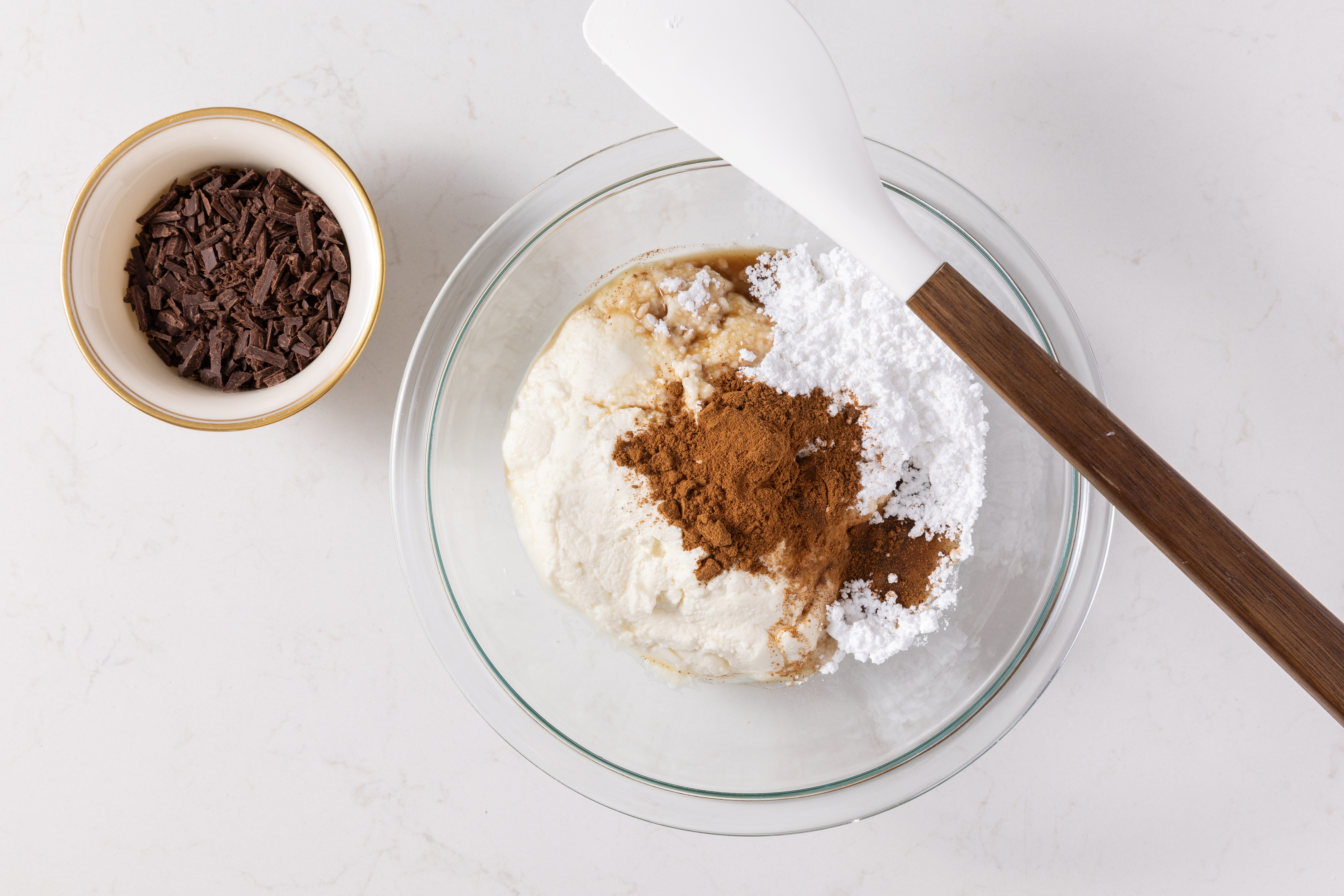 Ingredients for cake filling being combined in mixing bowl.