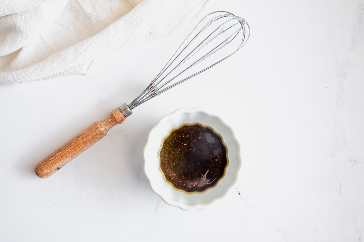 Overhead shot for Taste of Home Caprese Salad with dressing in a small bowl.