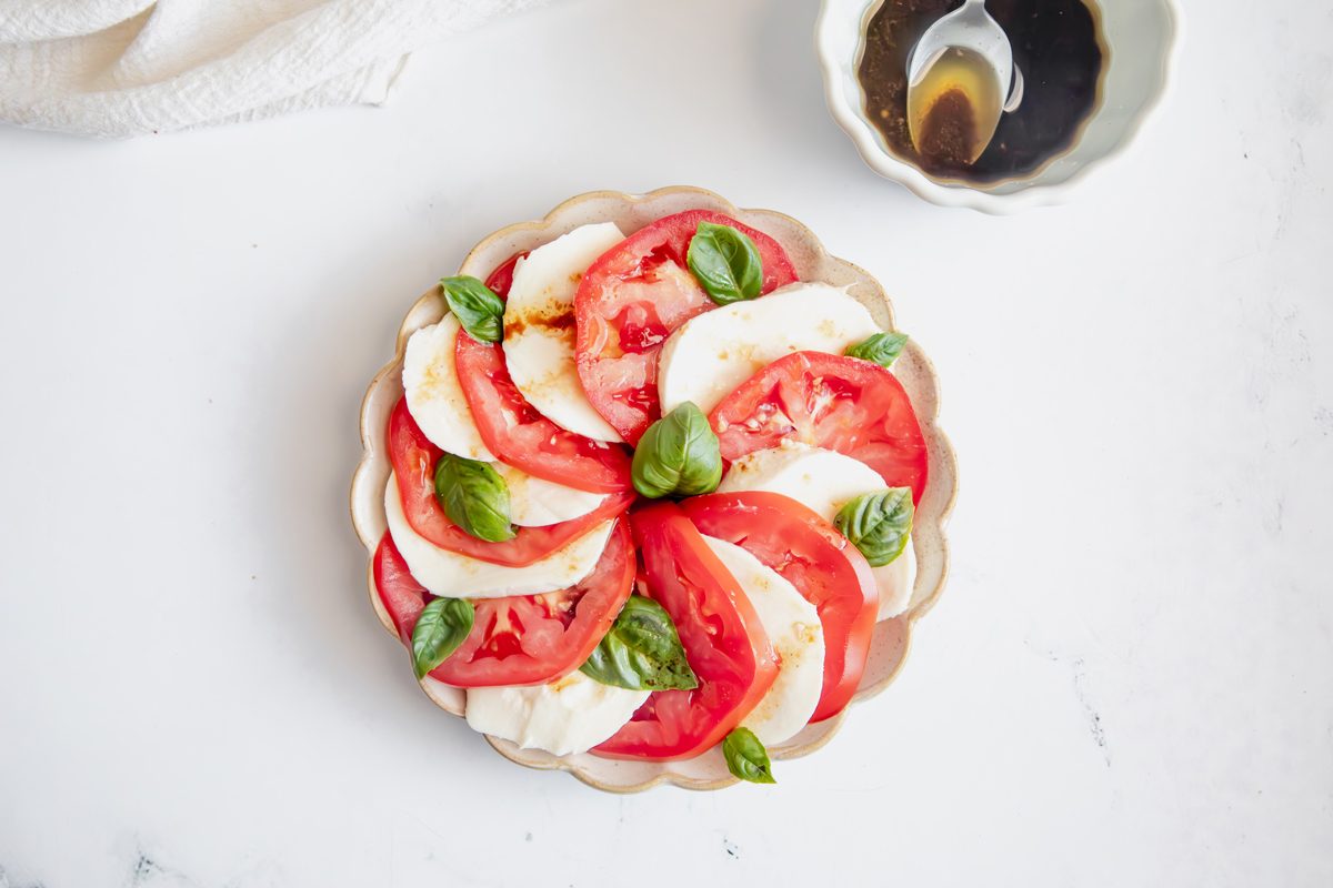 Overhead beauty shot for Taste of Home Caprese Salad with ingredients assembled on a plate.