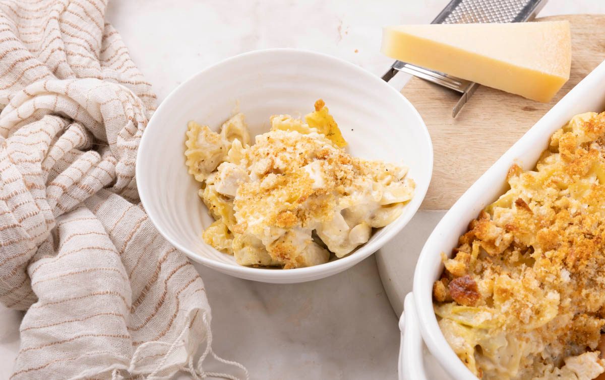 Chicken Artichoke Casserole in a blow next to the baked dish