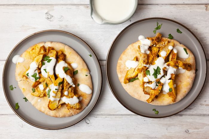 Two single servings of Taste of Home Chicken Shawarma with yogurt sauce