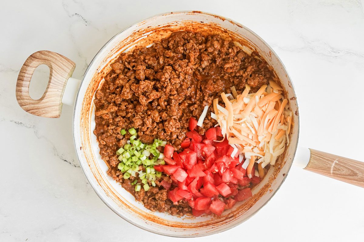 Filling for Taste of Home Chili Stuffed Poblano Peppers in a white skillet