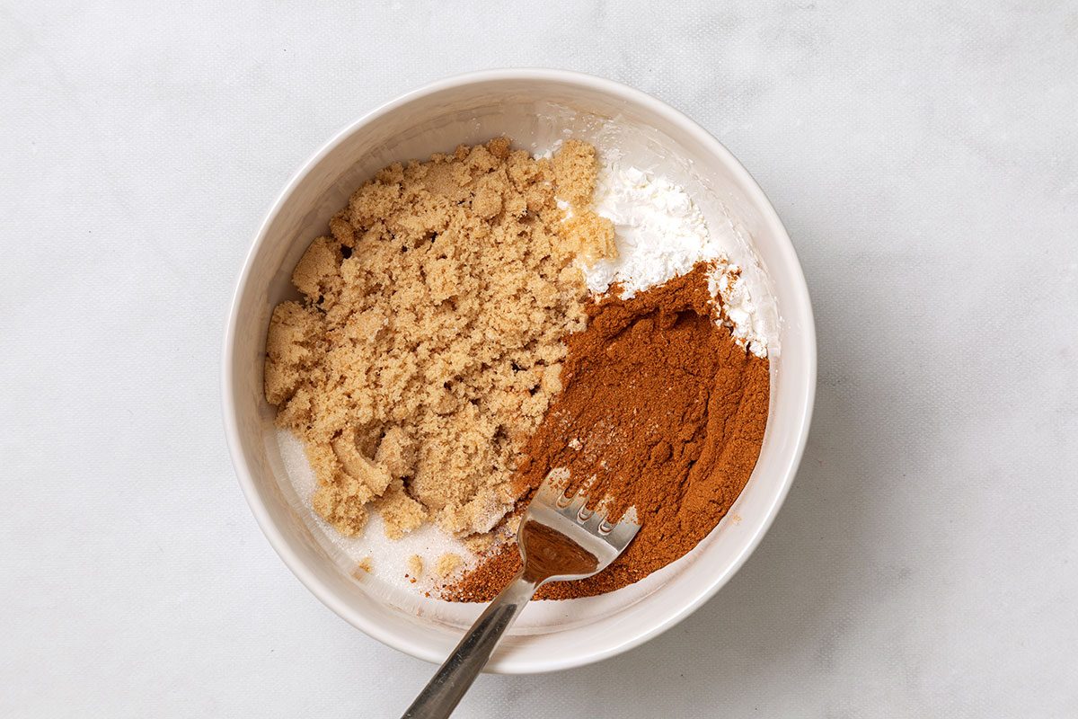 Sugar, brown sugar, cornstarch, cinnamon and nutmeg mixed in a small bowl for Cinnamon Apples for Taste of Home