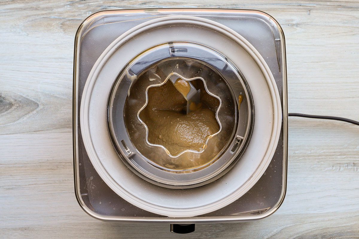 Churning coffee ice cream in an ice cream machine.