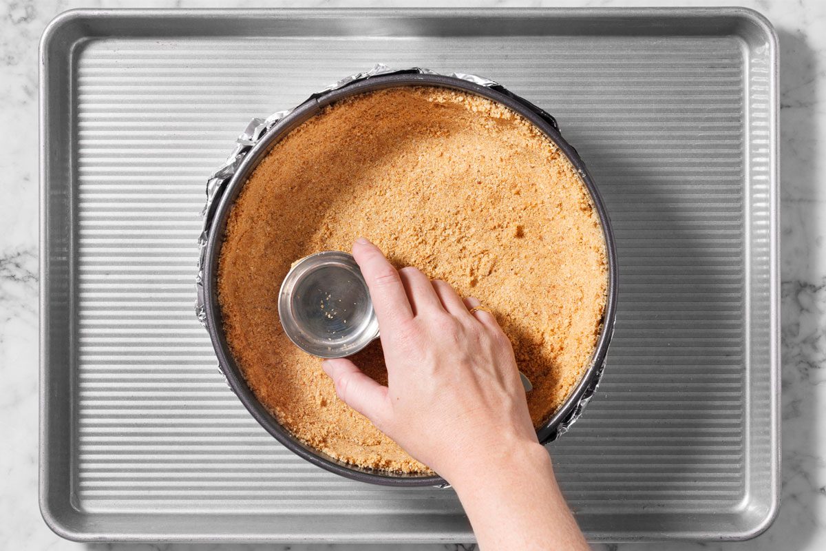 Press onto bottom and 1-1/2 in. up the side of prepared pan. Place on a baking sheet.