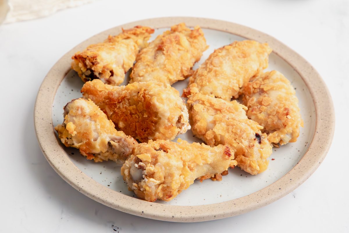 Close up beauty shot for Taste of Home Cornflake Chicken with chicken being served on a plate.