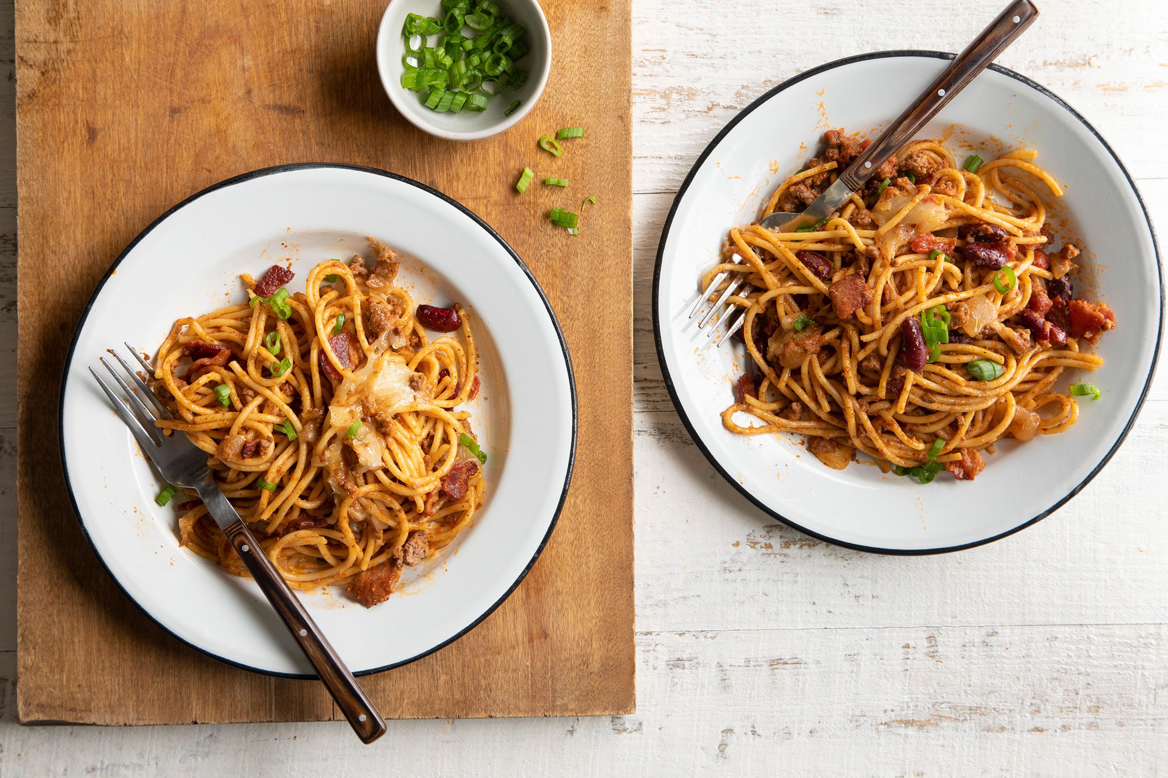 Cowboy Spaghetti served in two dishes with forks to eat