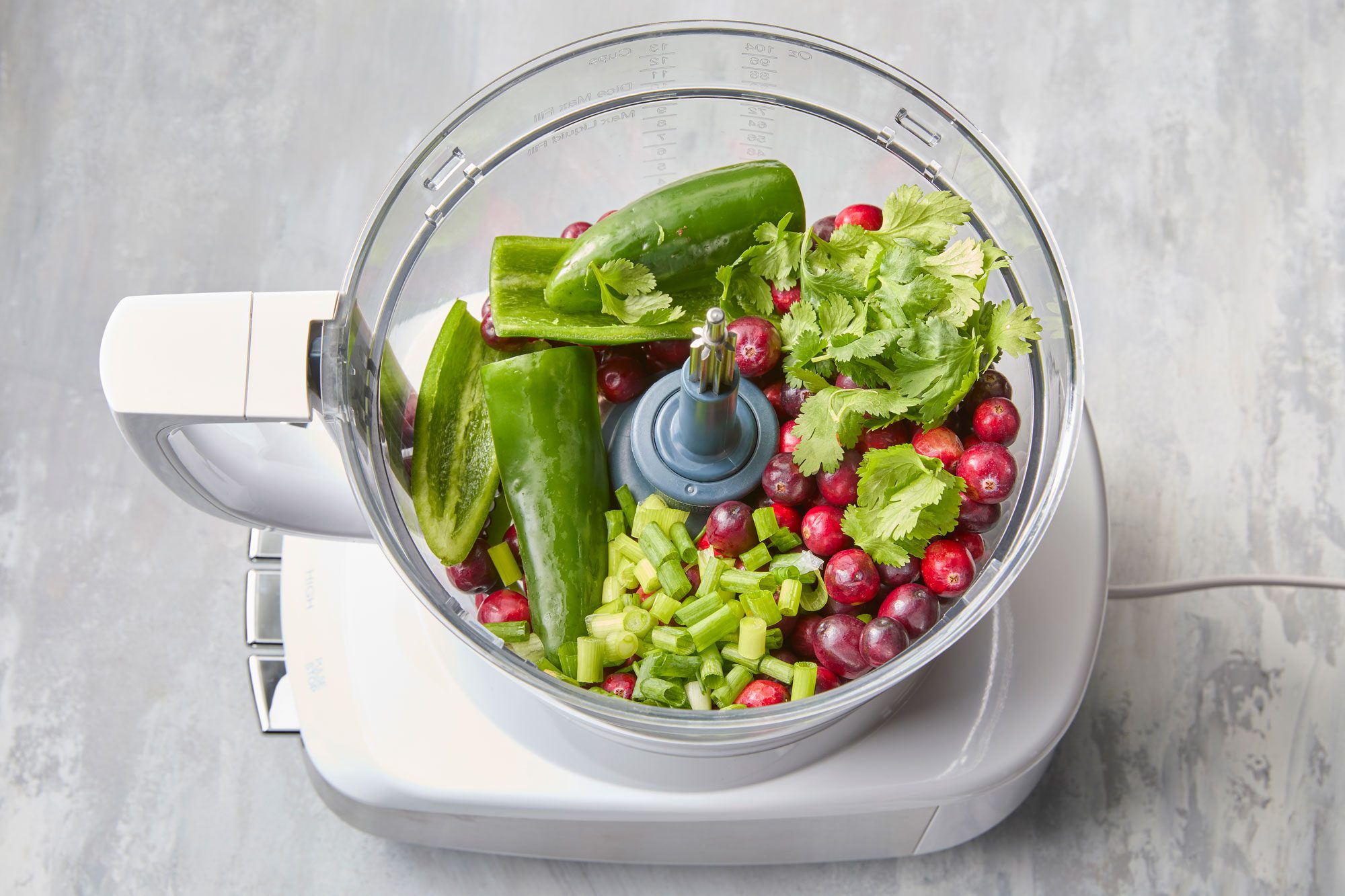 Place cranberries, jalapenos, green onion and cilantro into a food processor