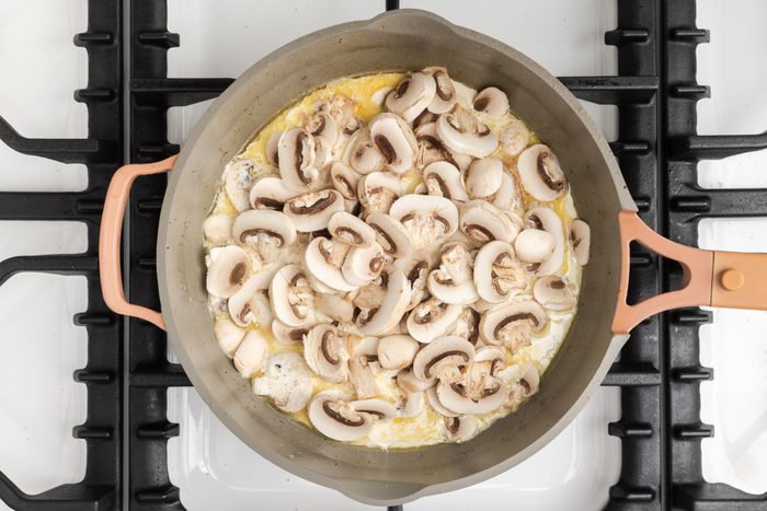 Mushrooms and cream being added to the sauce base.