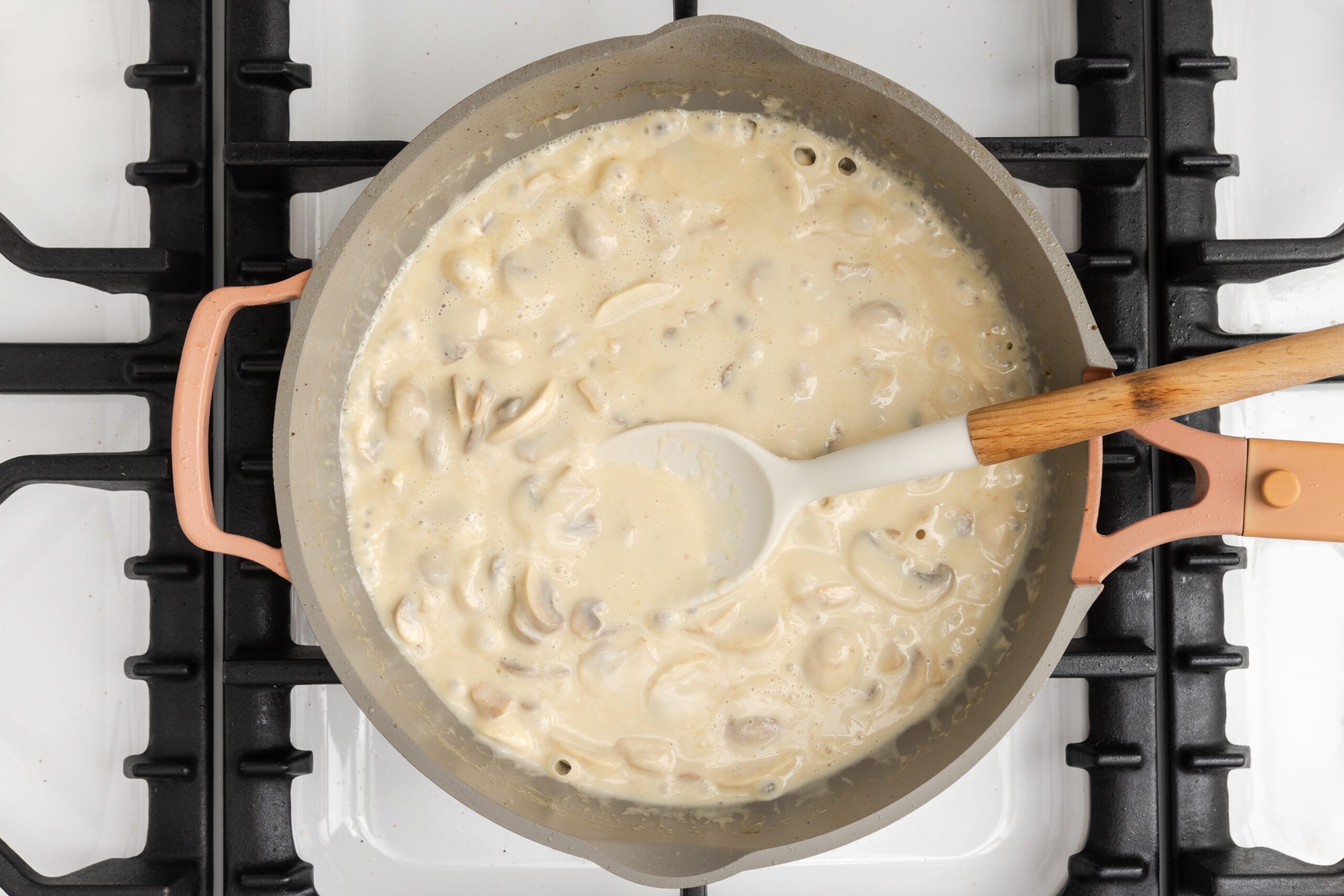 Creamy lemon chicken sauce being thickened.
