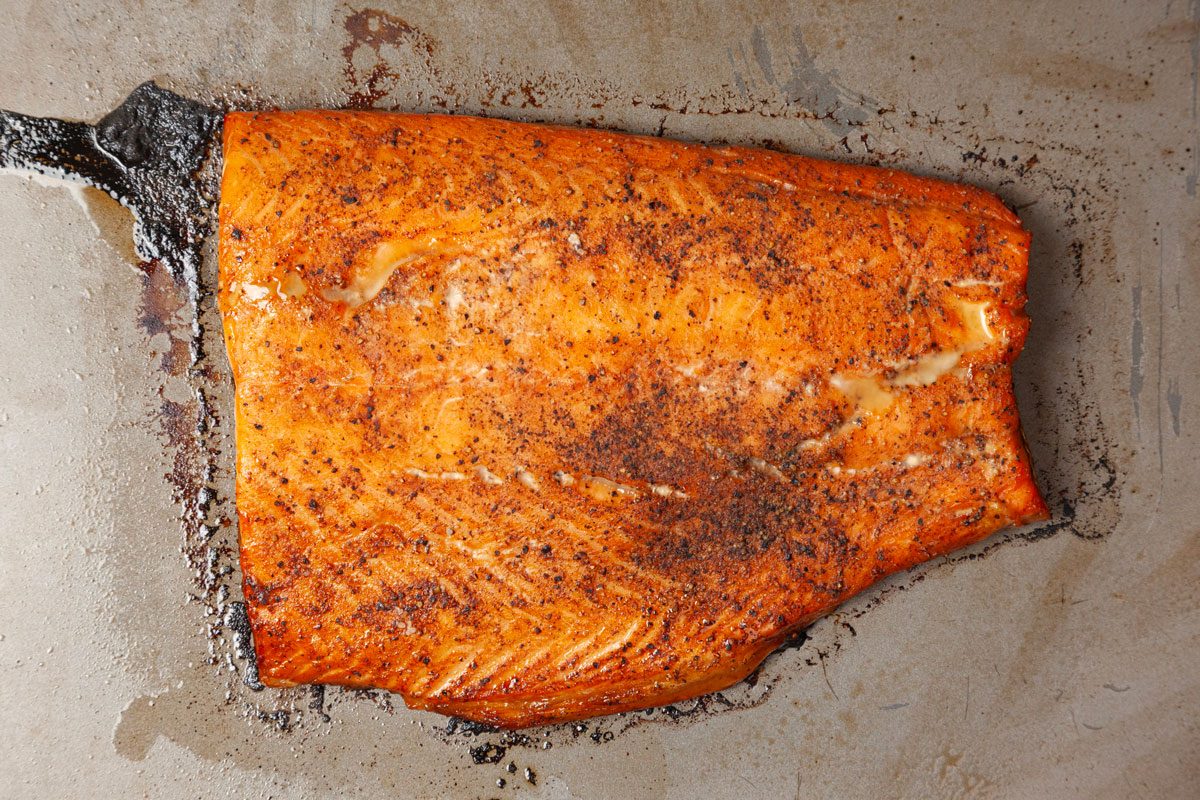 Step 2 of Taste of Home Smoked Salmon is to Drain the salmon and discard the liquid. Bake uncovered at 350°F until the fish flakes easily with a fork, about 35 to 45 minutes. Cool the salmon to room temperature and then cover and refrigerate it for 8 to 12 hours. If desired, serve your smoked salmon with capers and lemon slices.