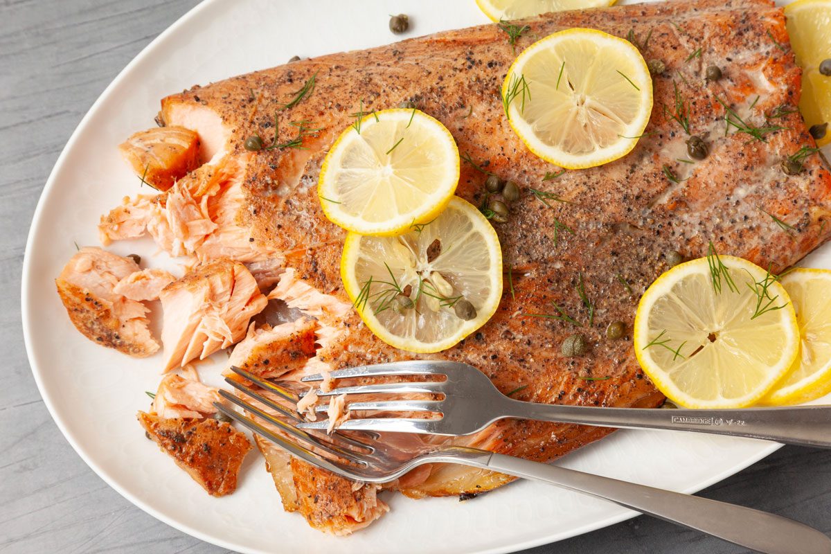 Full yield of Taste of Home Smoked Salmon garnished with lemon slices and capers