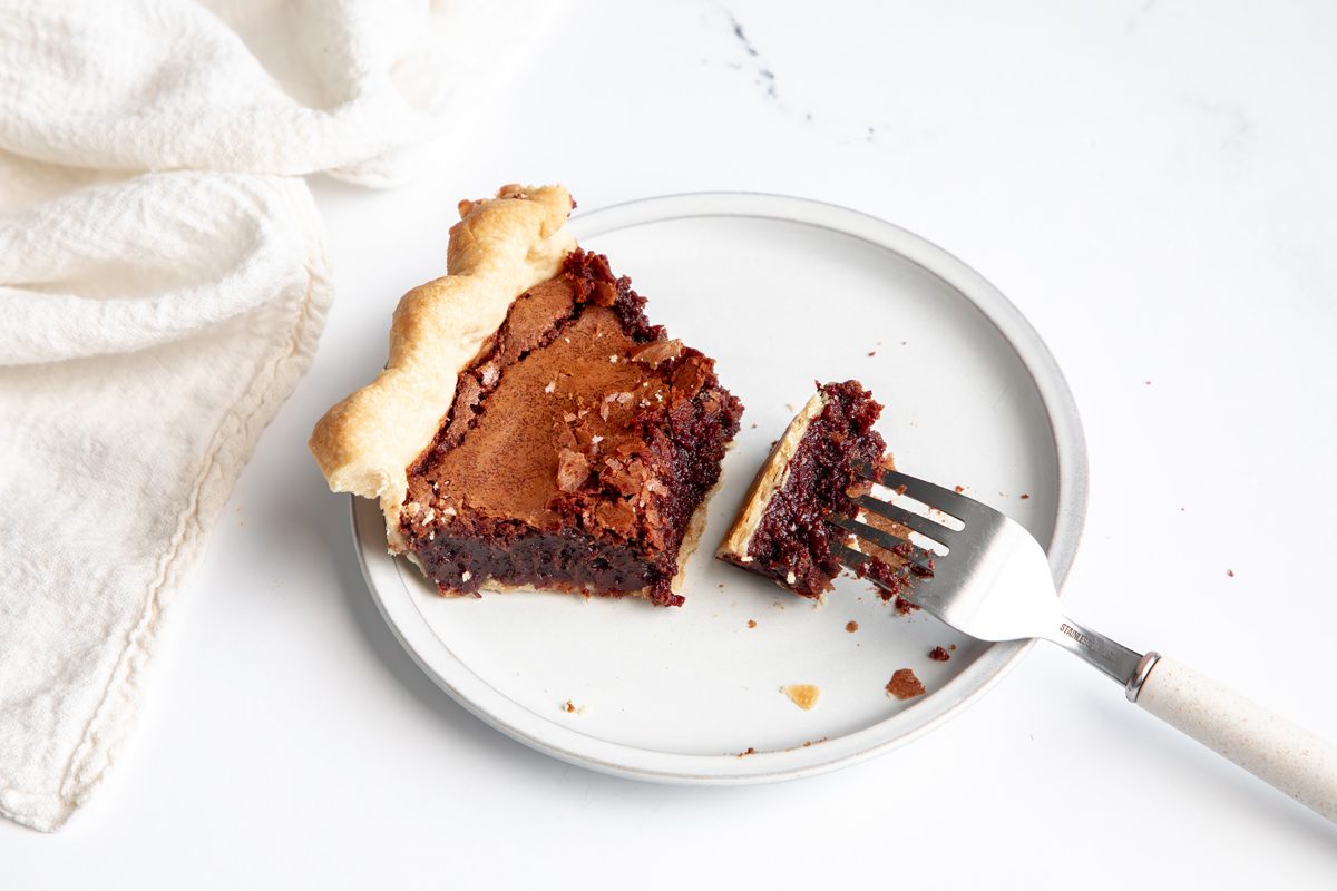 Beauty up shot for Taste of Home Fudge Pie, serving baked pie on a plate.