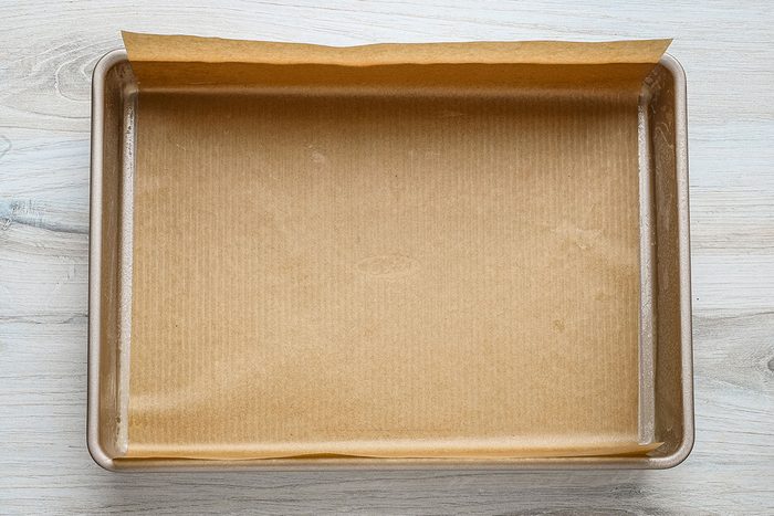 Parchment paper-lined baking pan for gingerbread blondies, a recipe from Taste of Home.