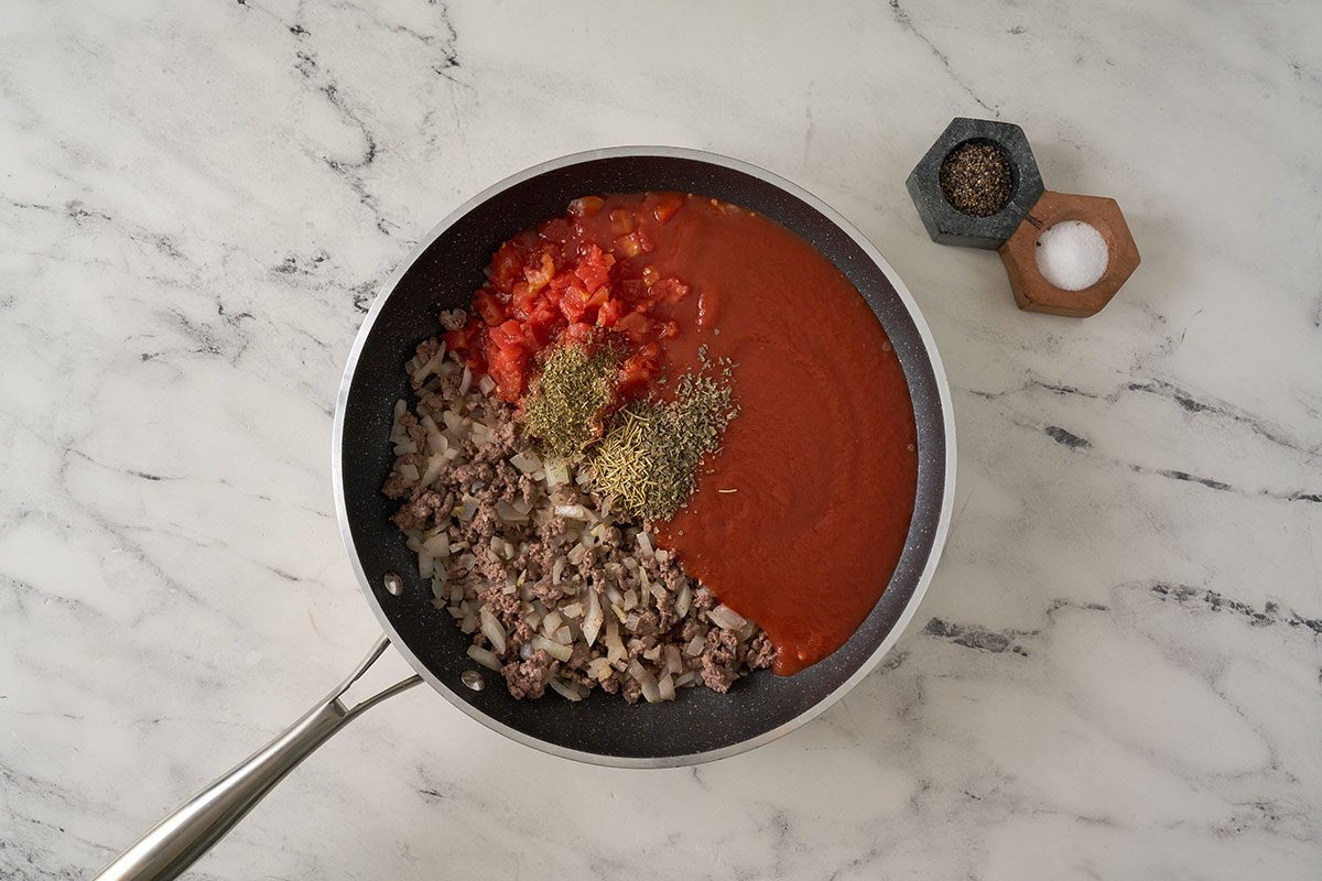 In a large saucepan, cook beef, onion, and garlic until the meat is no longer pink, then stir in tomato sauce, diced tomatoes, and seasonings. Bring to a boil, then simmer to blend the flavors for this Gnocchi Bolognese by Taste of Home.