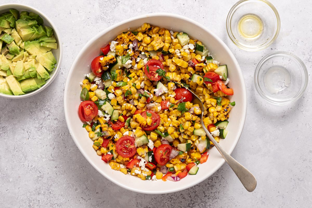 Grilled Corn Salad Ingredients Mixed Inside Bowl