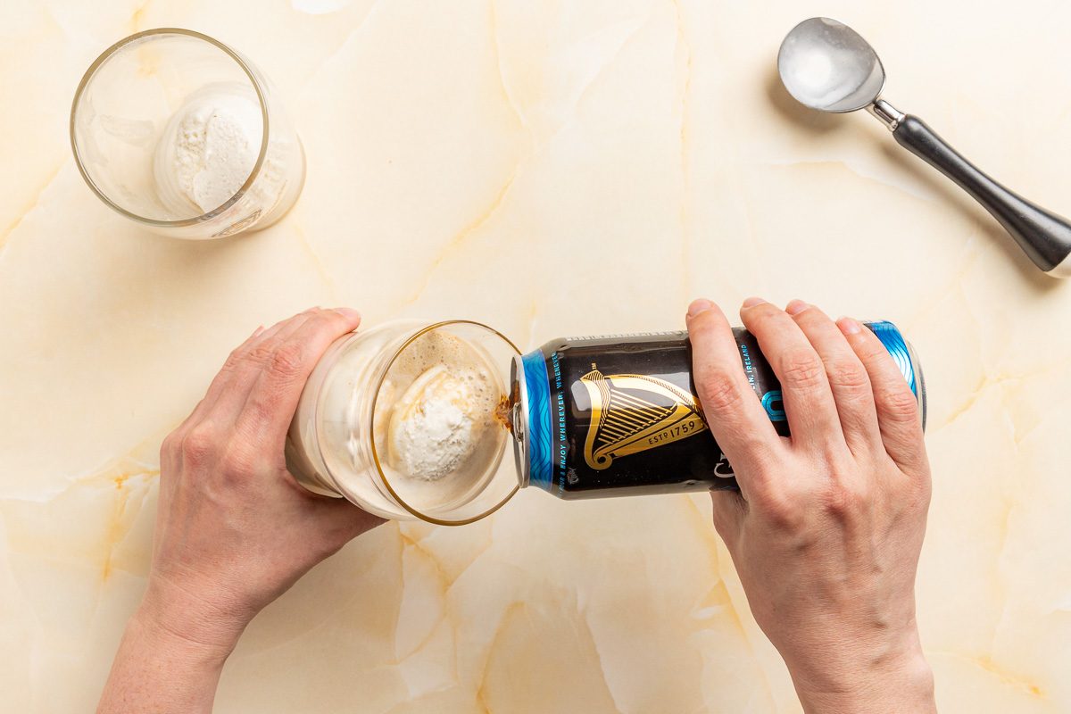 Taste of Home Guinness Float photo of pouring the stout into a vanilla ice cream filled pint glass.