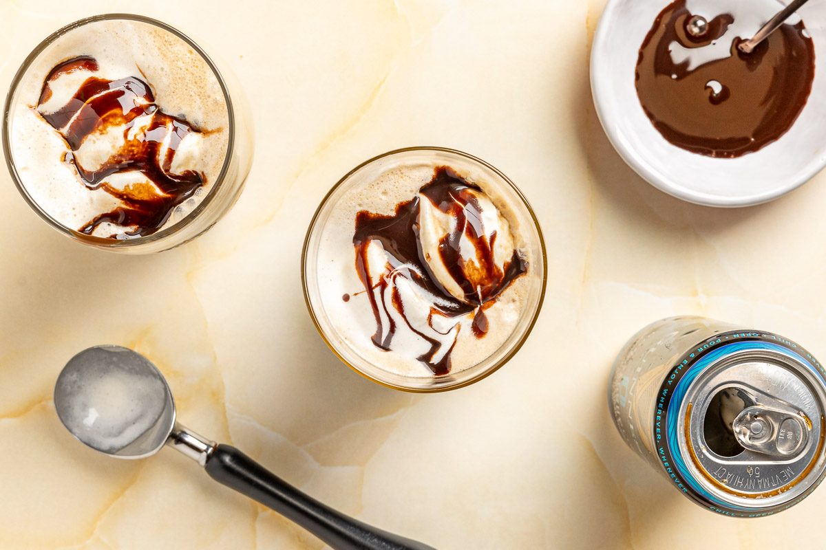 Taste of Home Guinness Float photo of drizzling chocolate syrup over the top of the float.