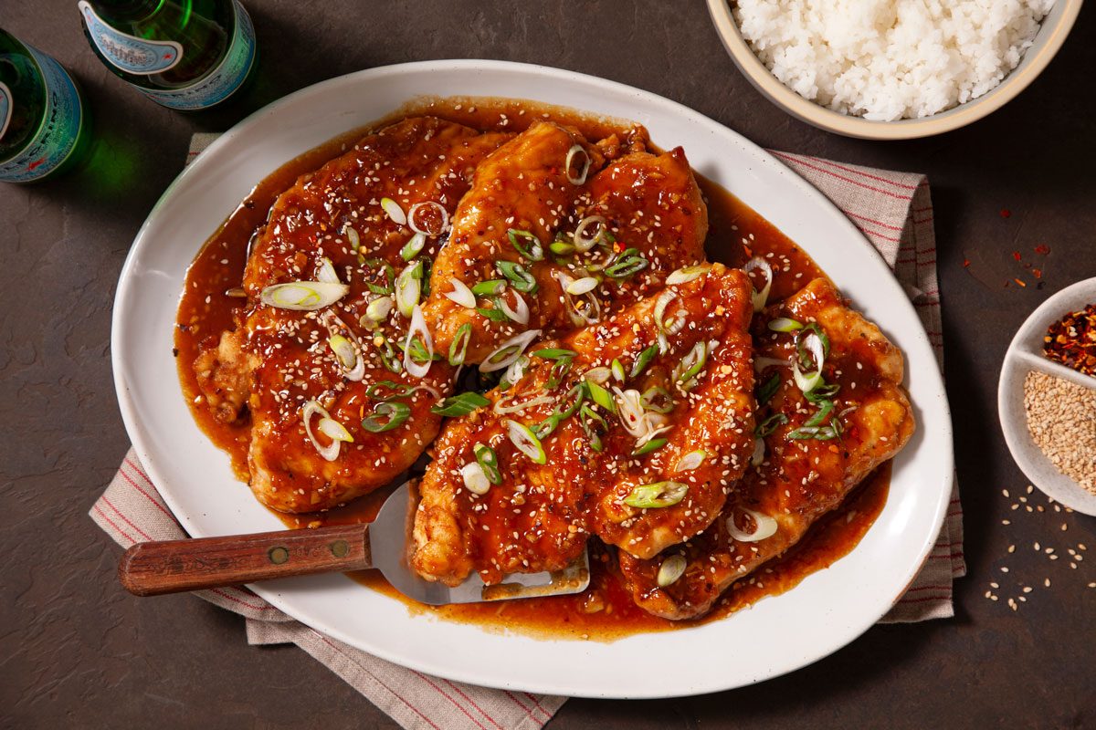 Honey Garlic Chicken on a white serving platter on a table