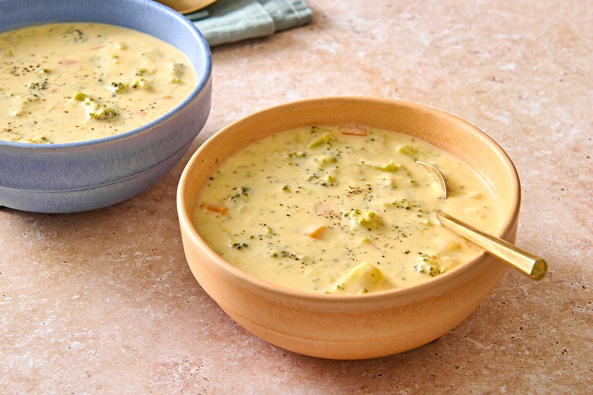Closeup of a bowl of Instant Pot broccoli cheddar soup with a spoon