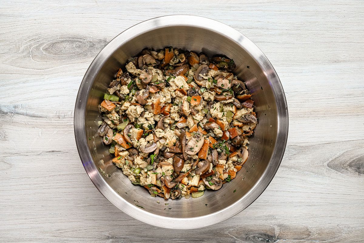 Keto stuffing preparation with low carb bread. mushrooms, sage, parsley, celery, and broth.
