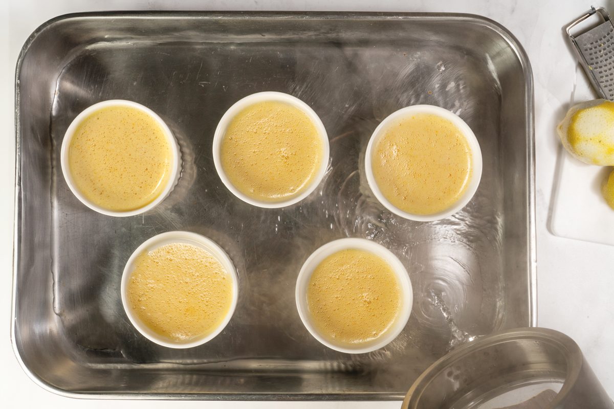 Placing the Lemon Creme Brulée in the oven