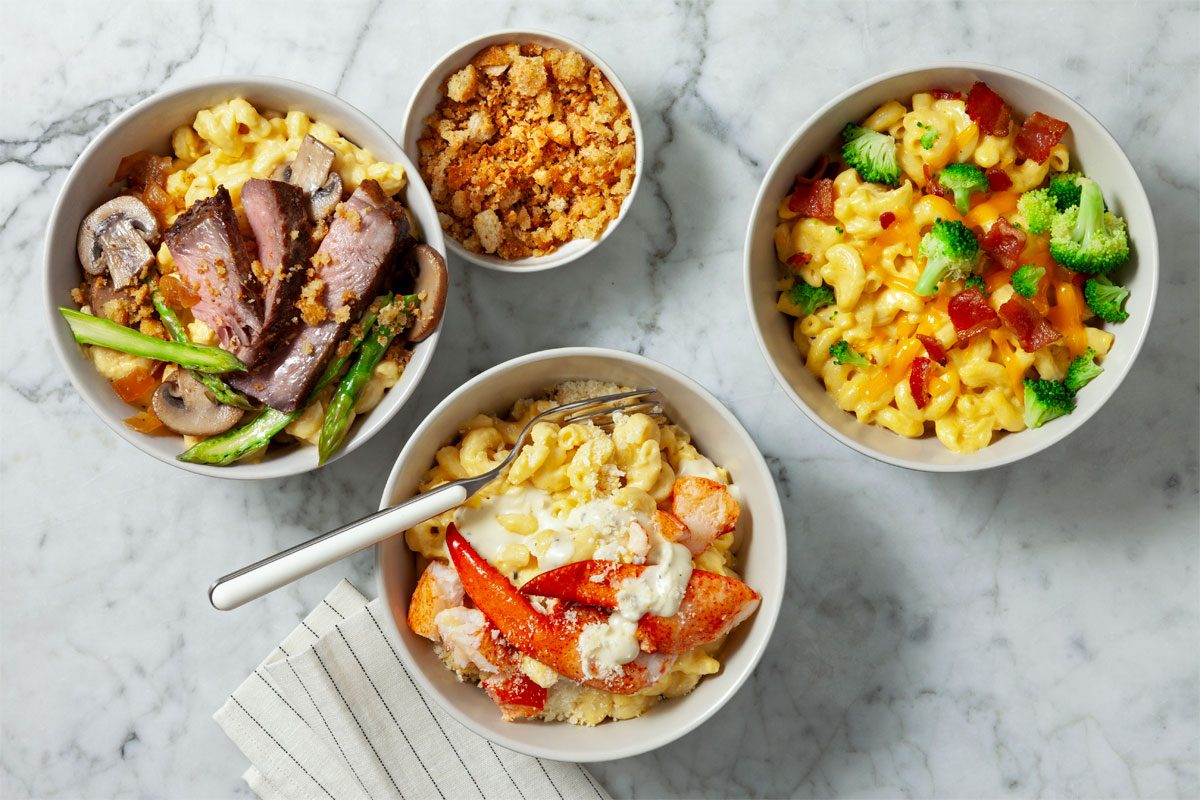 overhead shot of mac and cheese bar served with bowls filled with topping options.