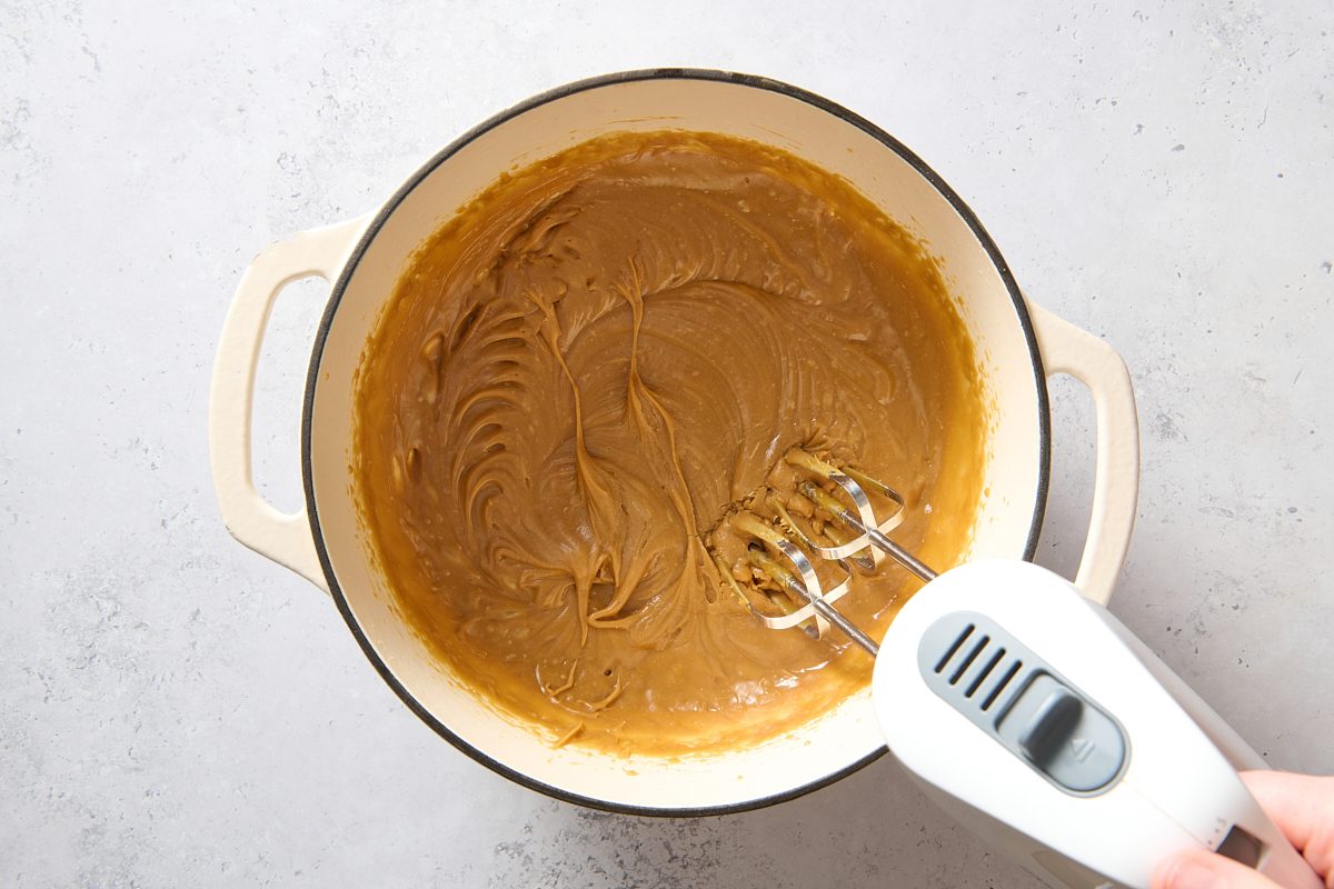 Beating the fudge mixture in a Dutch oven