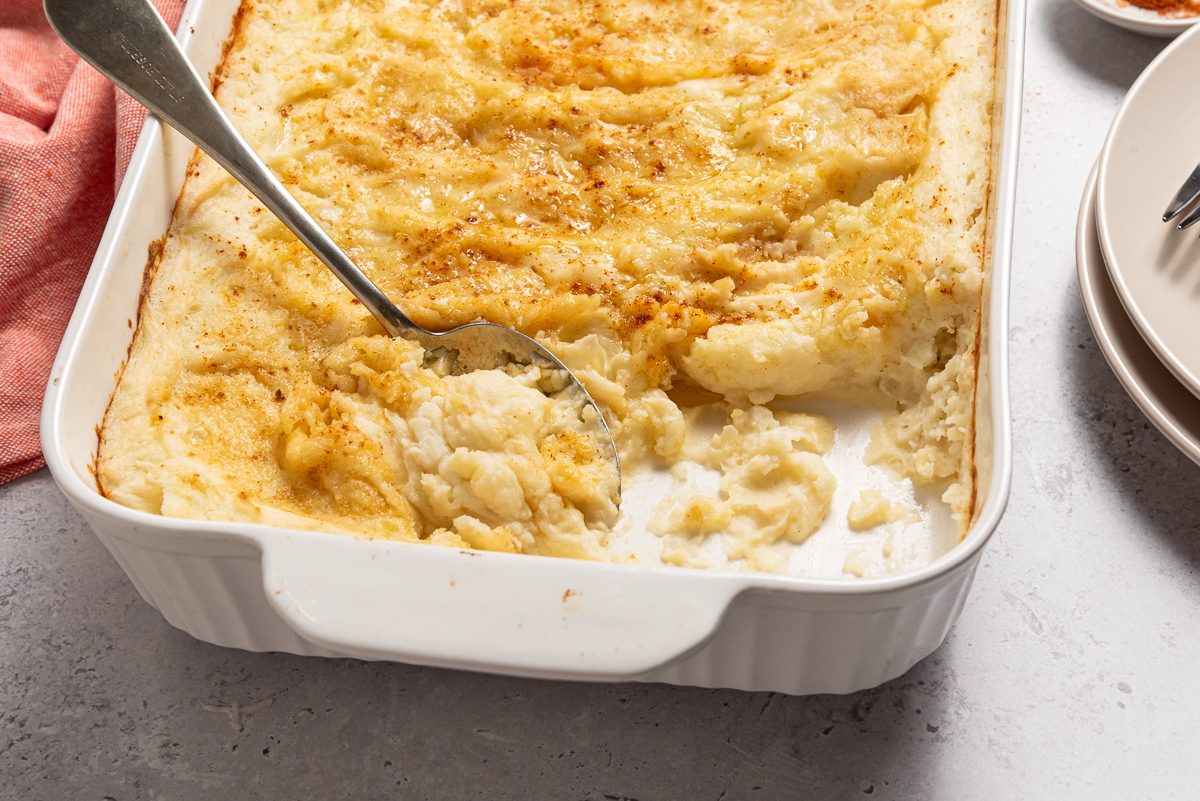 Spoon In Baking Dish With Mashed Potato Casserole