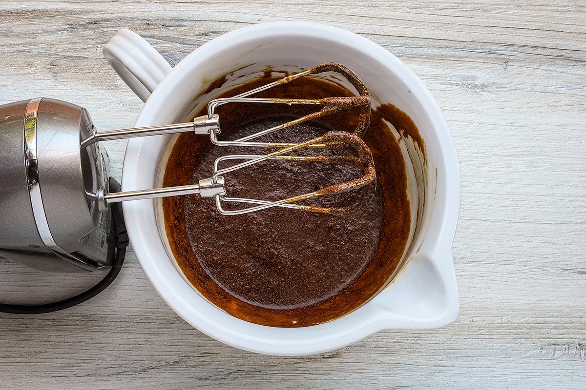 Beating the sugar, molasses, and egg for an old-fashioned molasses cake from Taste of Home.