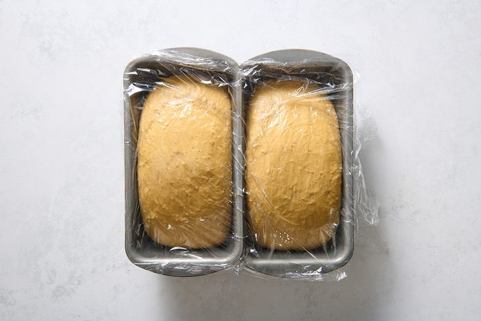 Dough formed into loaves and left to rise in two loaf tins
