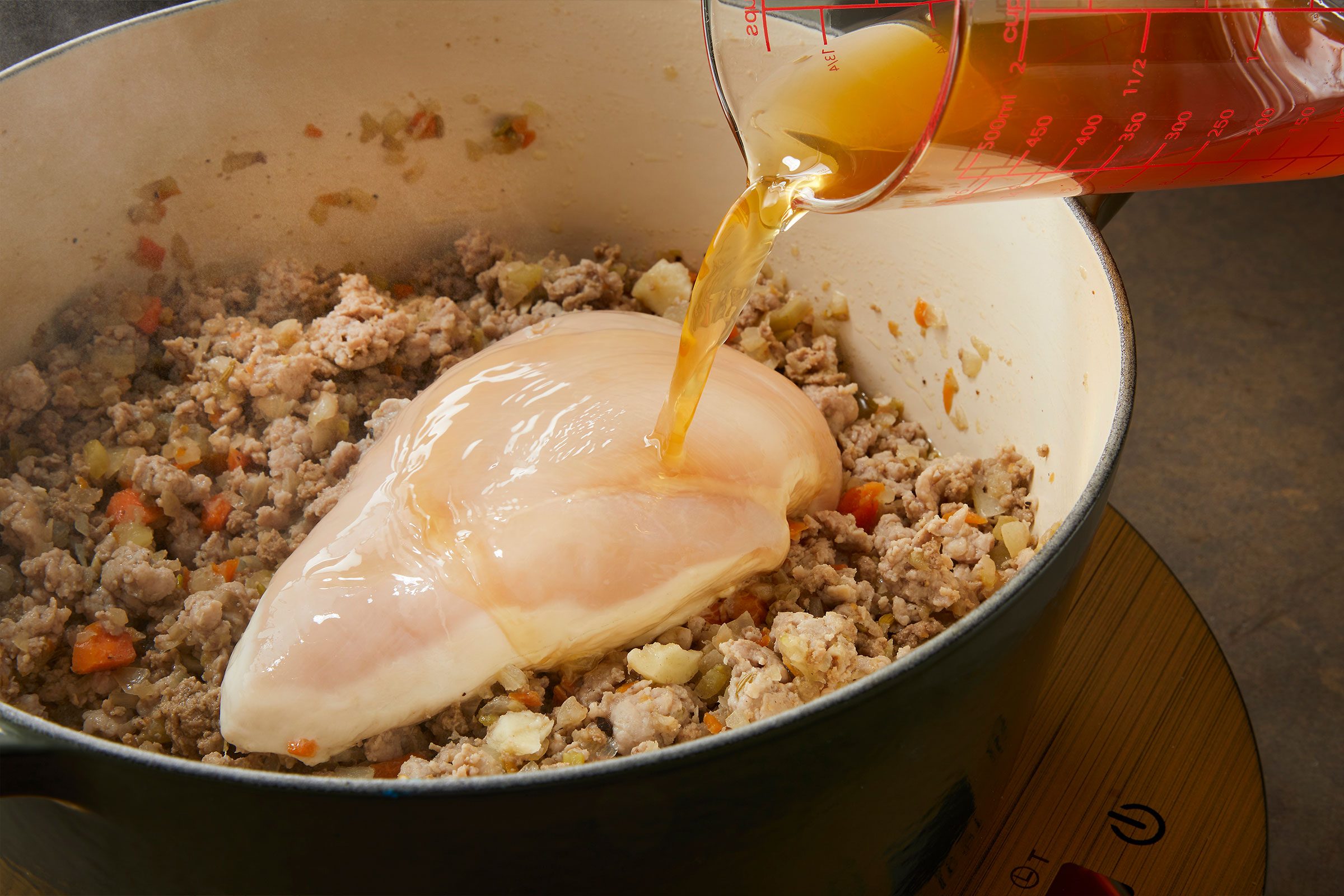 Adding chicken to cook in preparation of Pappardelle Bolognese