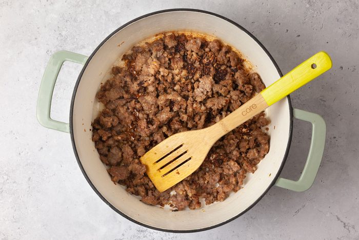 Step 2 of Taste of Home Pasta with Sausage & Peas is to brown the sausage and the garlic