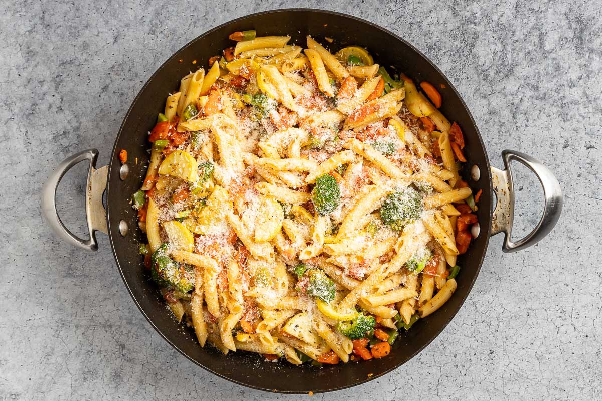 Taste of Home Pasta with Veggies photo of the pasta added to the skillet, tossed with the veggies and topped with Parmesan cheese.