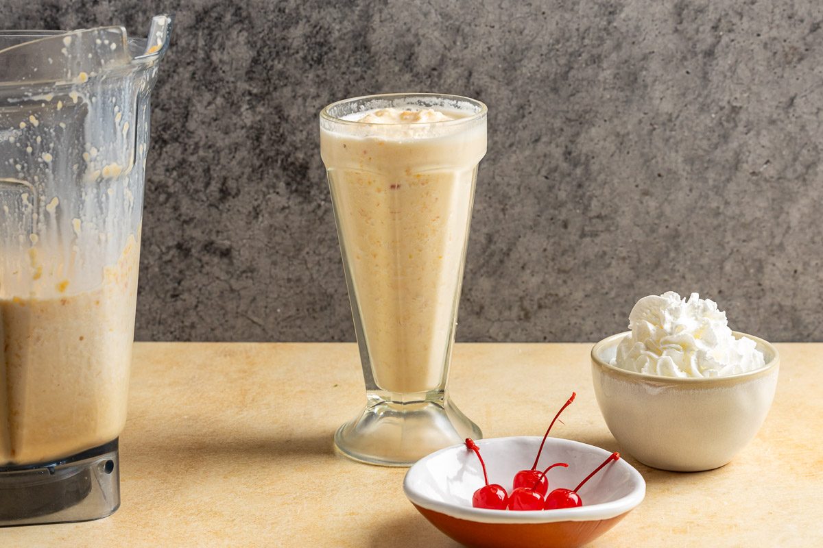 Taste of Home Peach Milkshake photo of the blended milkshake poured into a glass.