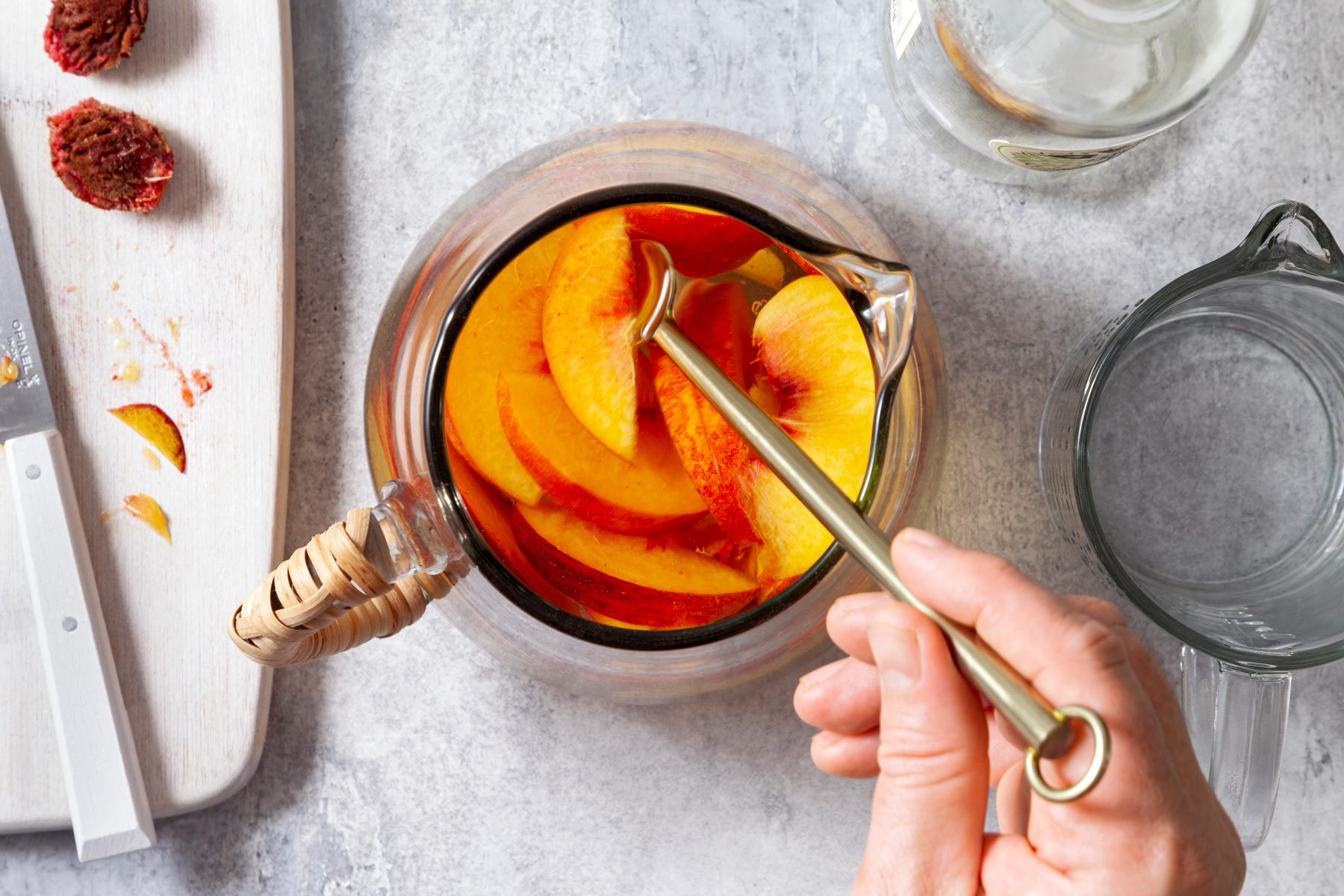 AN overhead shot of pitcher filled with peaches.