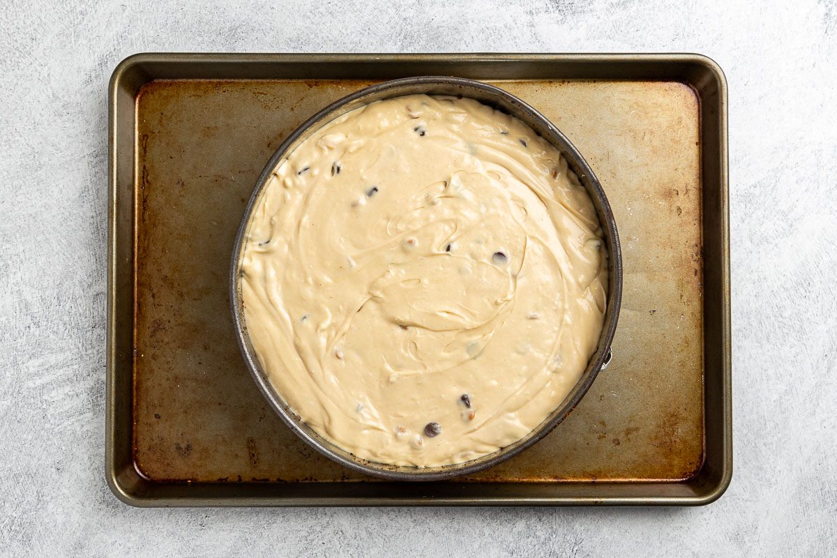 uncooked cheesecake on a baking sheet