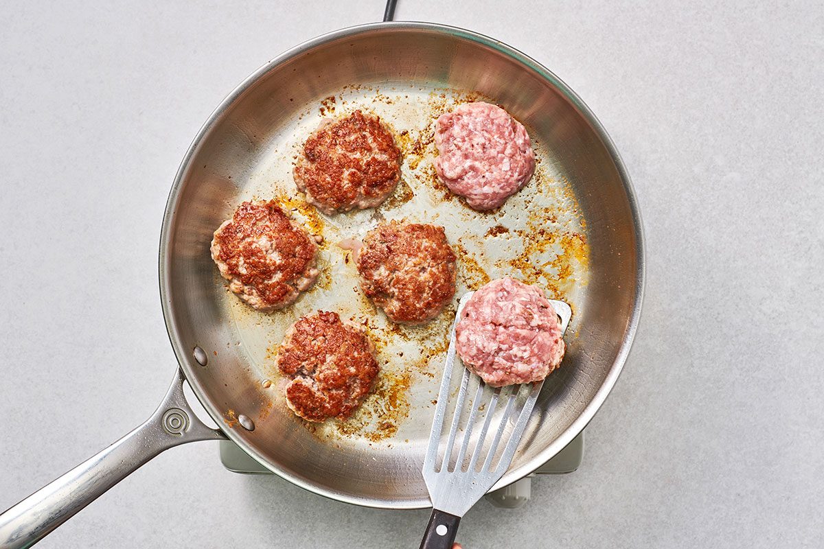 Frying pork patties in a skillet