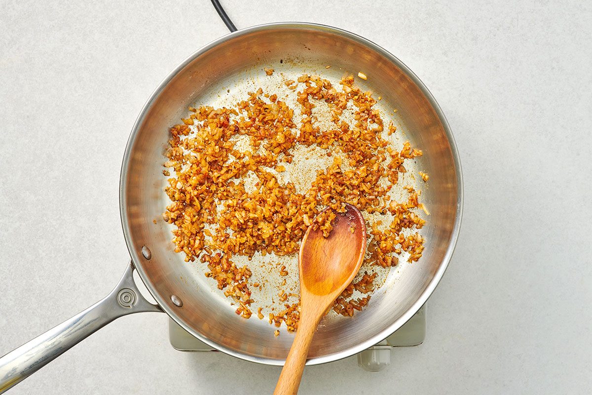 In a large skillet onions sautéed until translucent with garlic cumin oregano chili powder and cayenne 