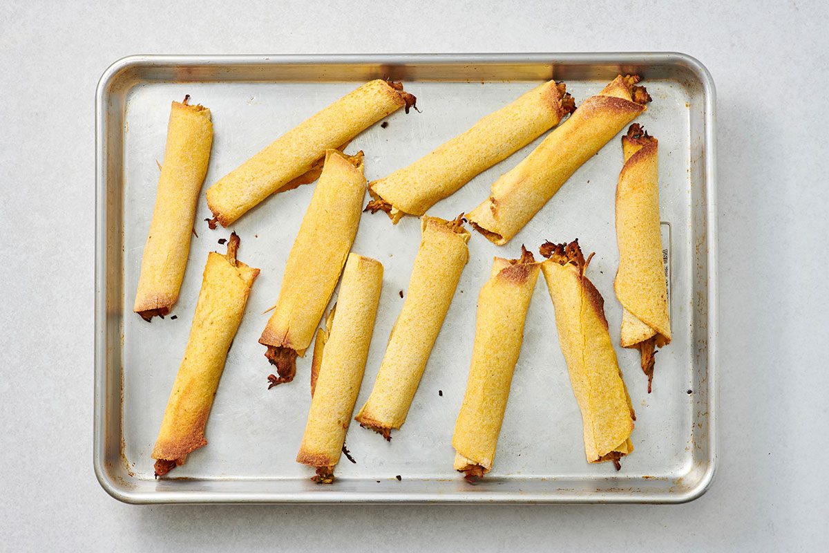 Baked pork taquitos on a sheet pan 