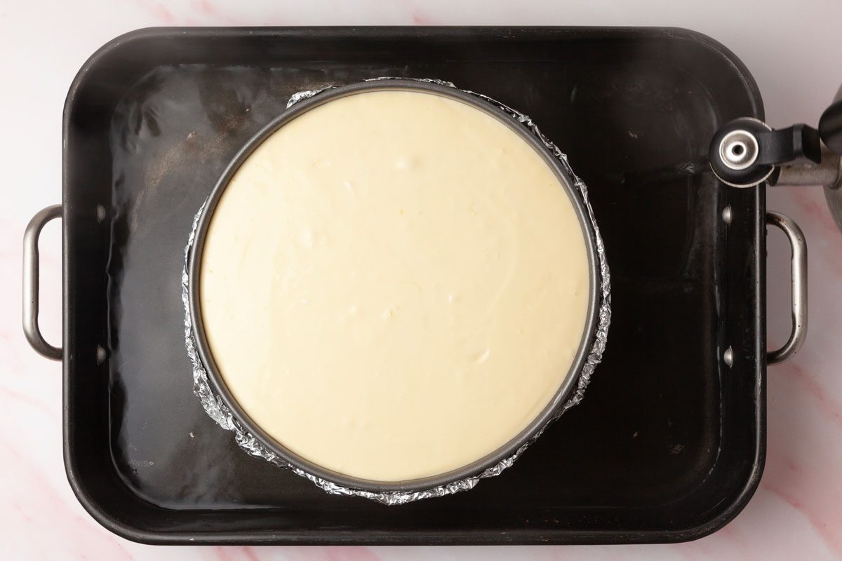 Step 3 of Taste of Home Raspberry Cheesecake is to Pour the filling over the cooled crust. Place the springform pan inside a larger baking pan and add an inch of hot water to the larger pan to create a water bath. Bake for 15 minutes, then reduce the oven temperature to 225° and bake for an additional 1-1/4 hours.