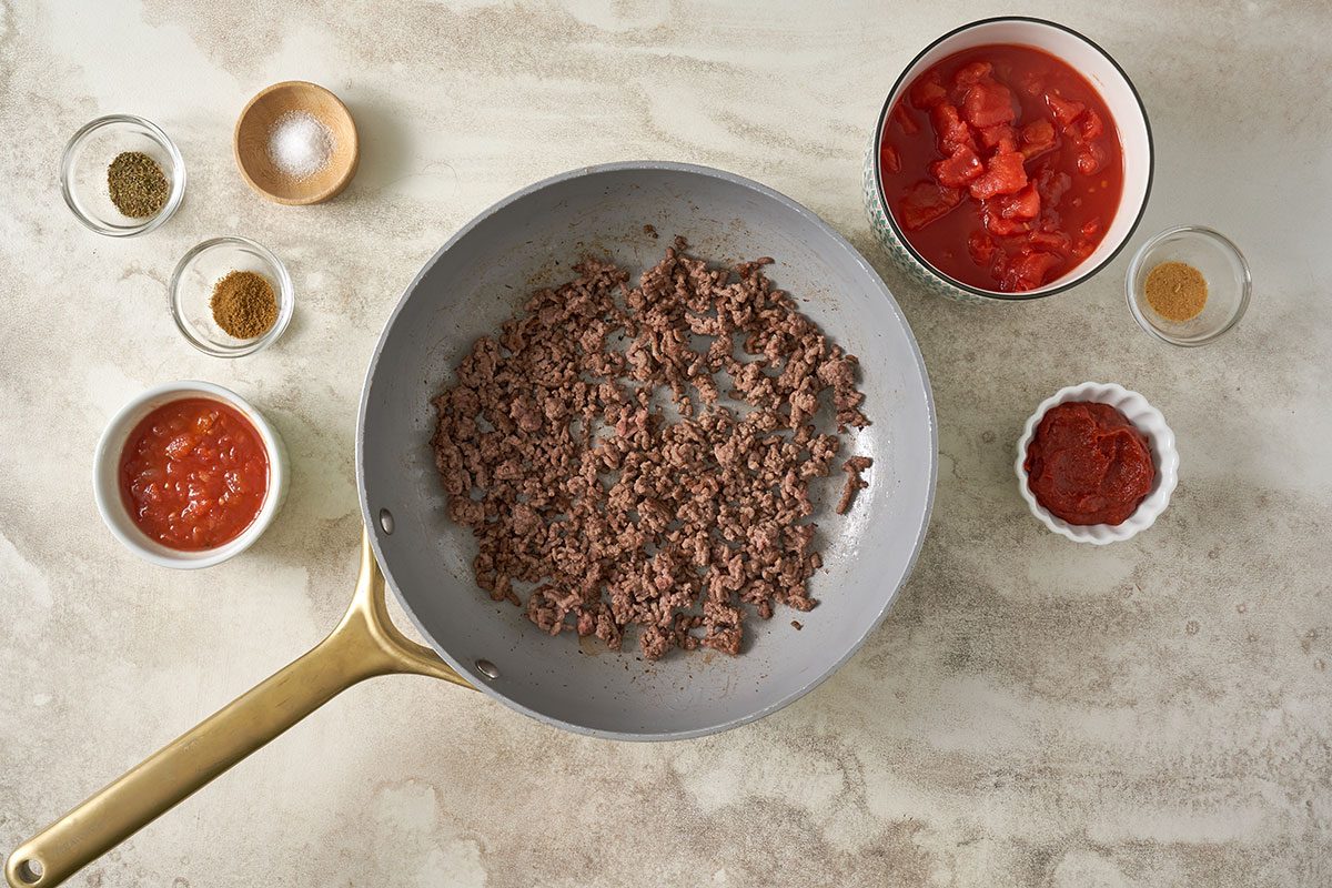 Ground beef, diced tomatoes, salsa, and spices simmering in a pan to create the flavorful sauce for Salsa Pasta. Taste of Home recipe.