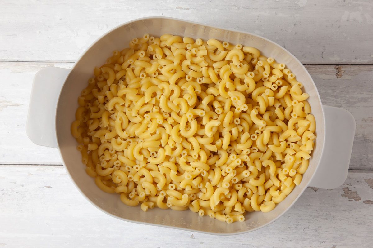 Step 1 of Taste of Home Sausage Mac and Cheese is to cook the macaroni according to the package's directions. Drain and set aside.