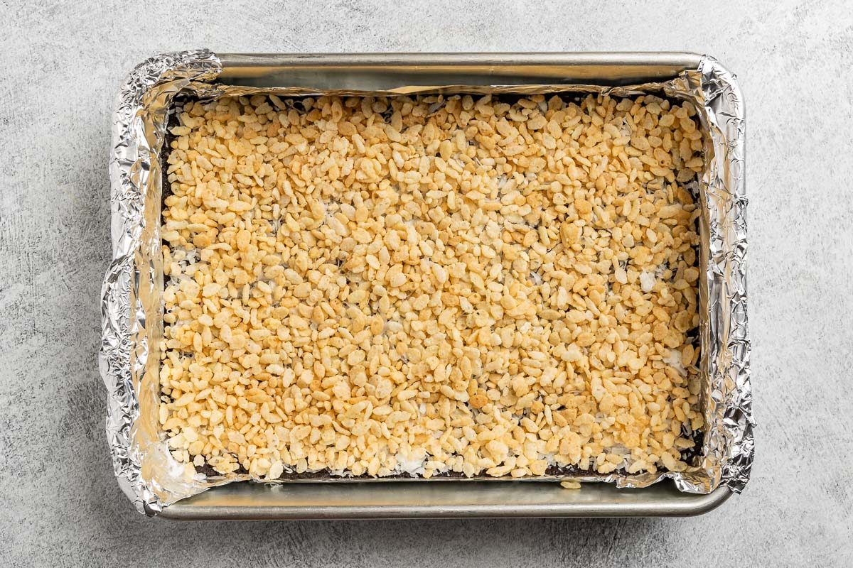  preparing the lower layers of the cookies in a baking pan.