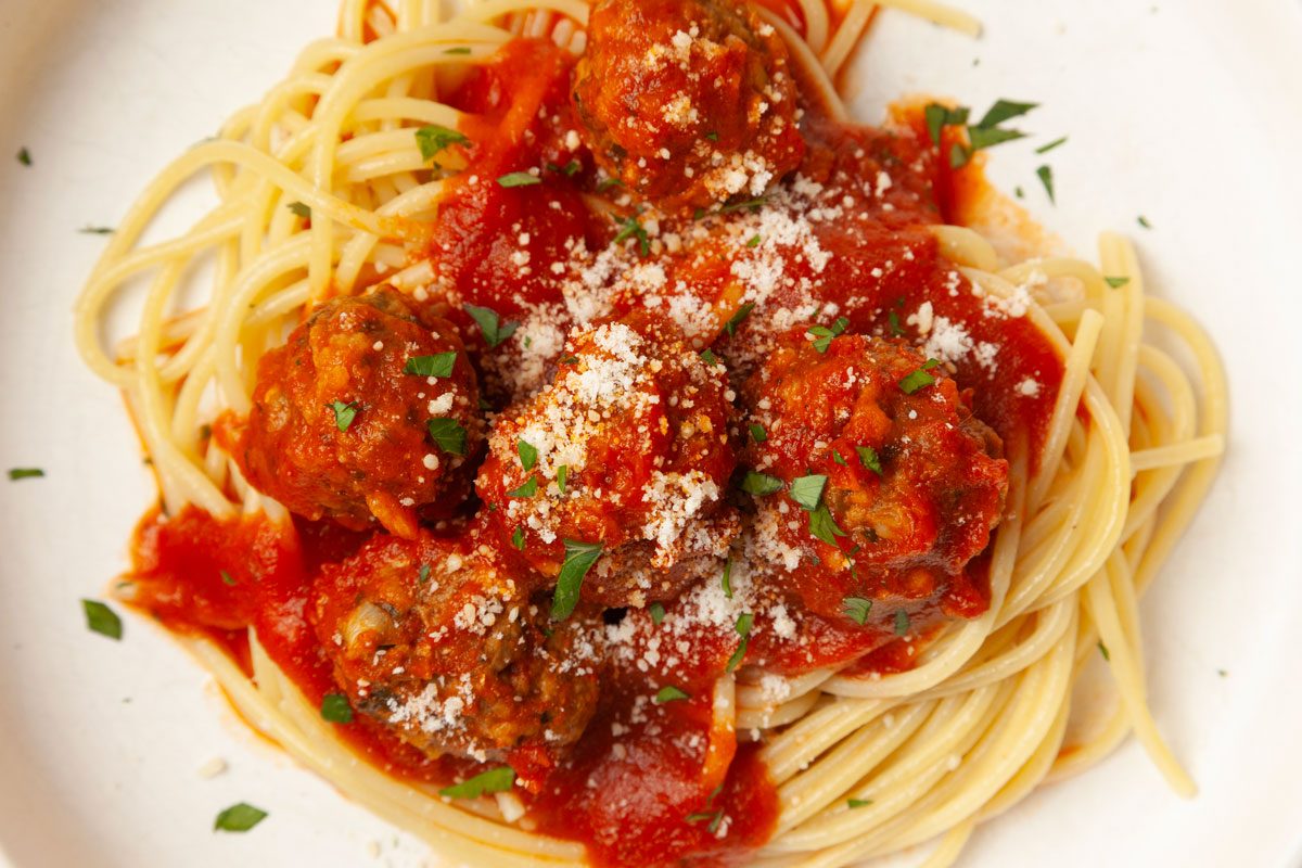 Single servings of Taste of Home Slow-Cooked Italian Meatballs garnished with parmesan cheese and parsley.