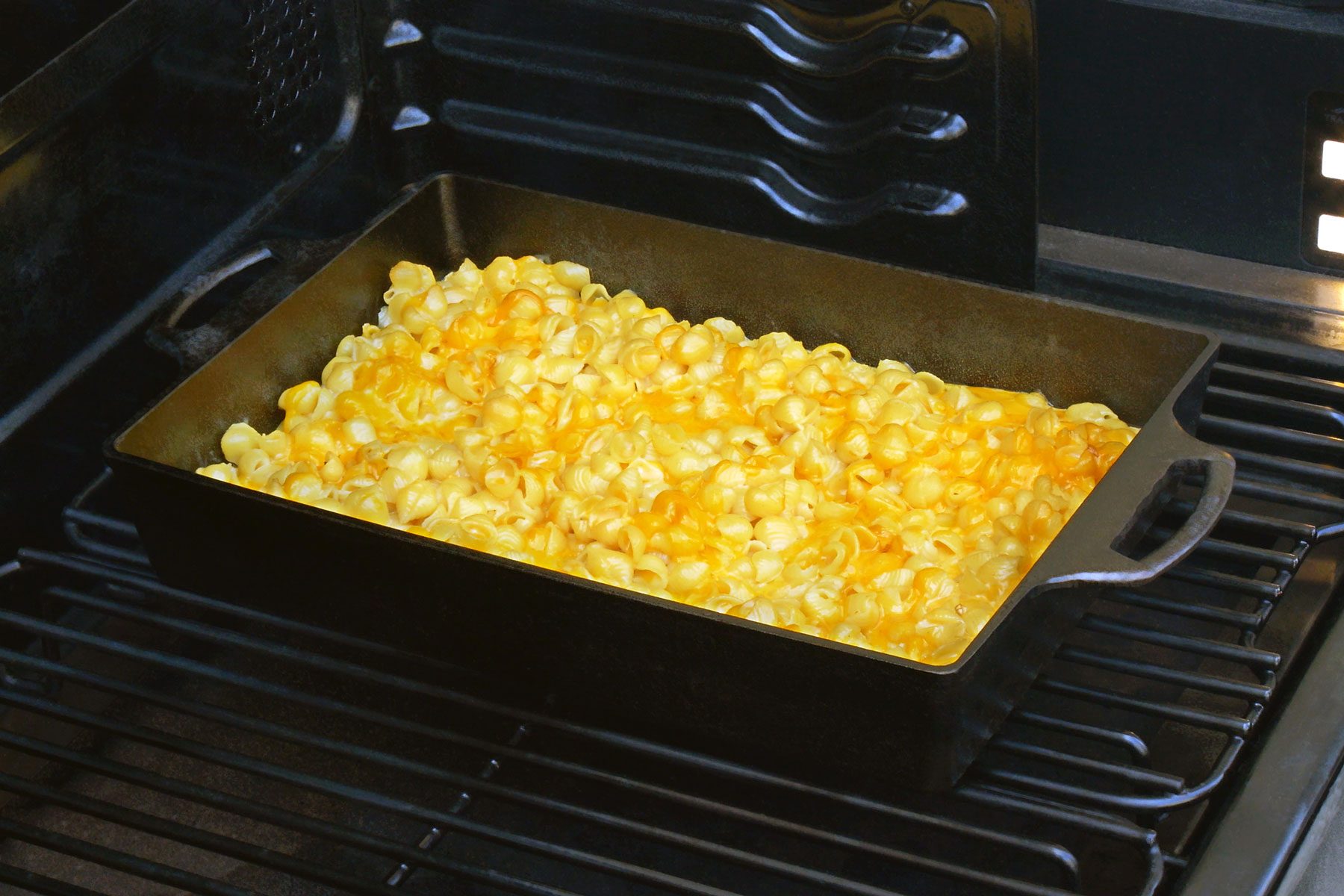 Baking pan with pasta placed on grill.