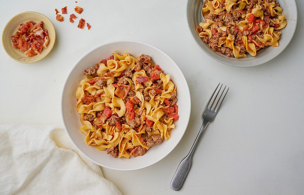 Overhead shot of Taste of Home's Spanish Noodles recipe, plated and topped with bacon